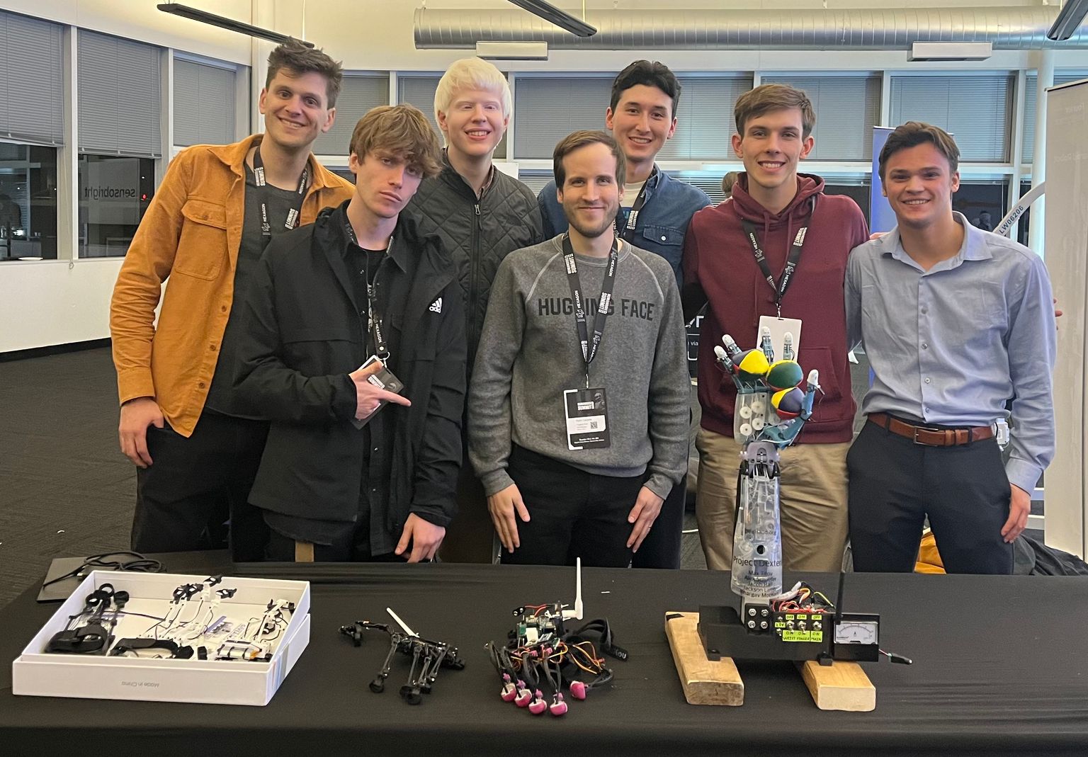 The Project Dexterity team and fellow attendees behind the robotic hand and control gloves at Humanoids Summit