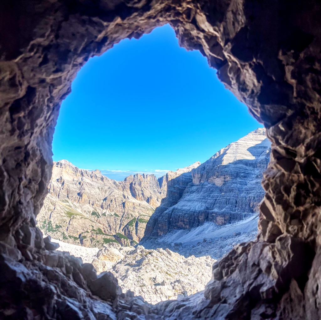Mountain peaks framed by an opening in the rock